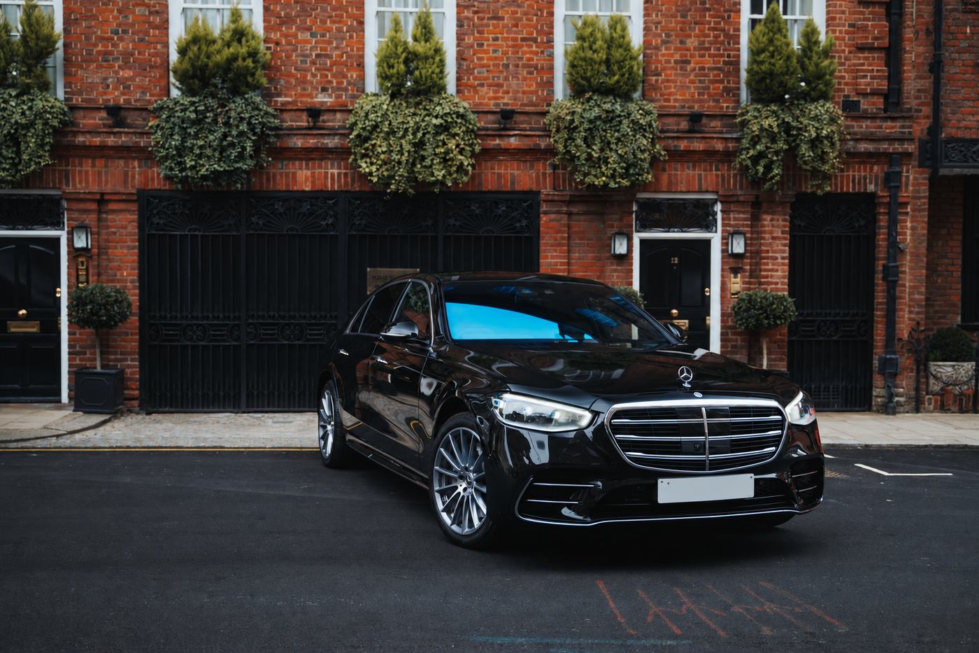 Mercedes-Benz S-Class parked outside a red-brick London house