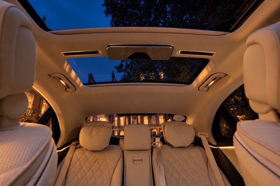 Mercedes-Benz S-Class white rear cabin beneath the glass roof at dusk